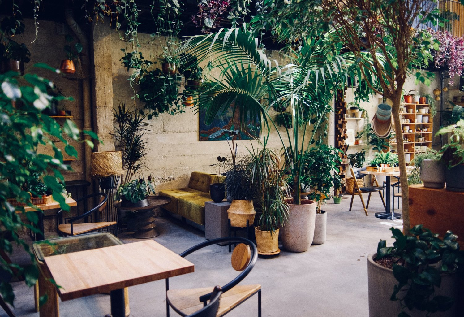 a living room filled with furniture and vase of flowers on a table