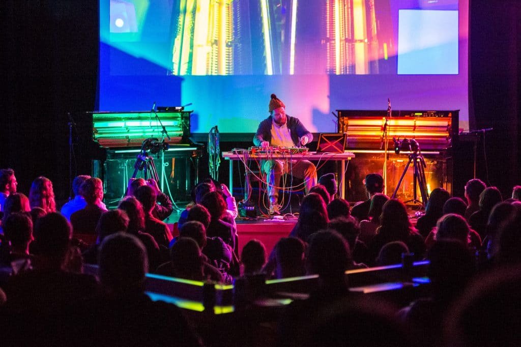 a group of people on a stage in front of a crowd