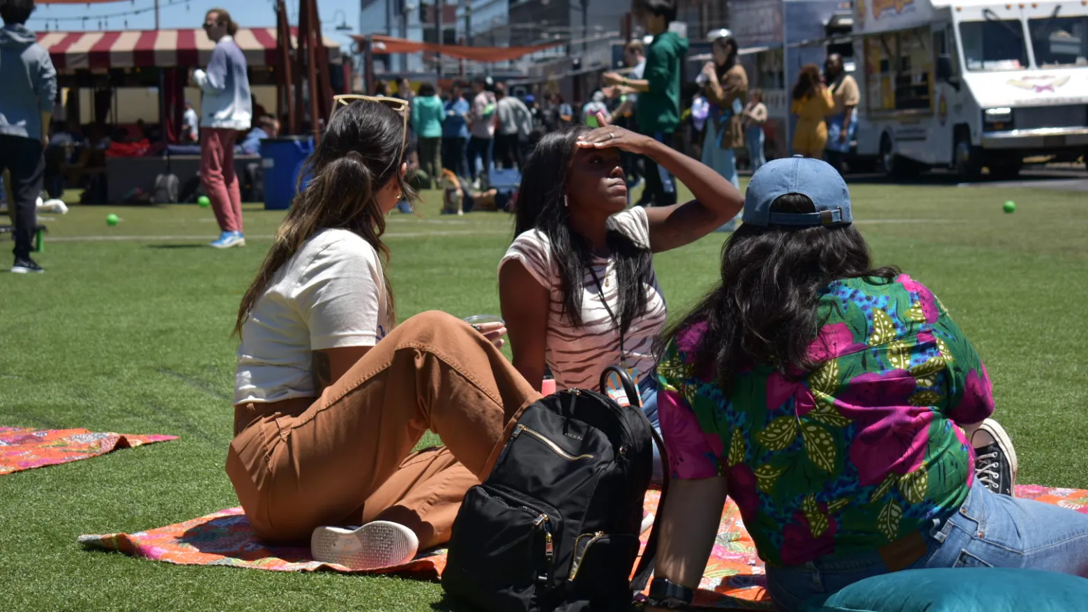 a group of people sitting in a chair talking on a cell phone