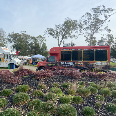 a bus traveling on a train track with trees in the background