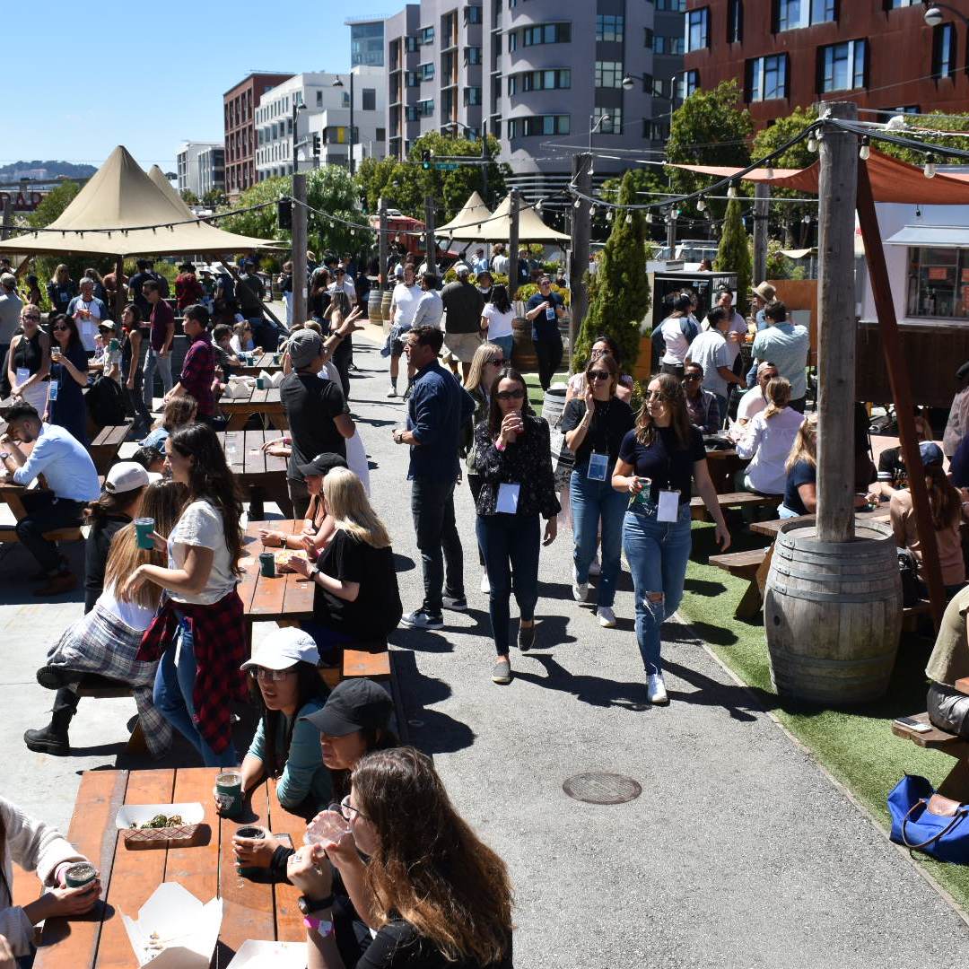 a group of people sitting at a crowded street