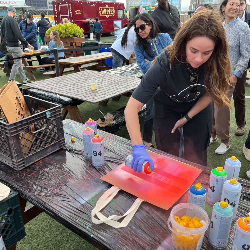a group of people standing around a table