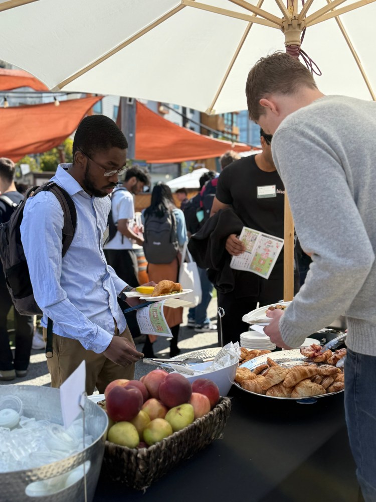 a group of people sitting at a table with food