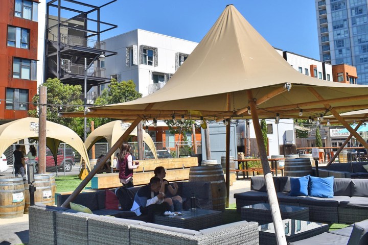 a group of people sitting at a table in front of a building