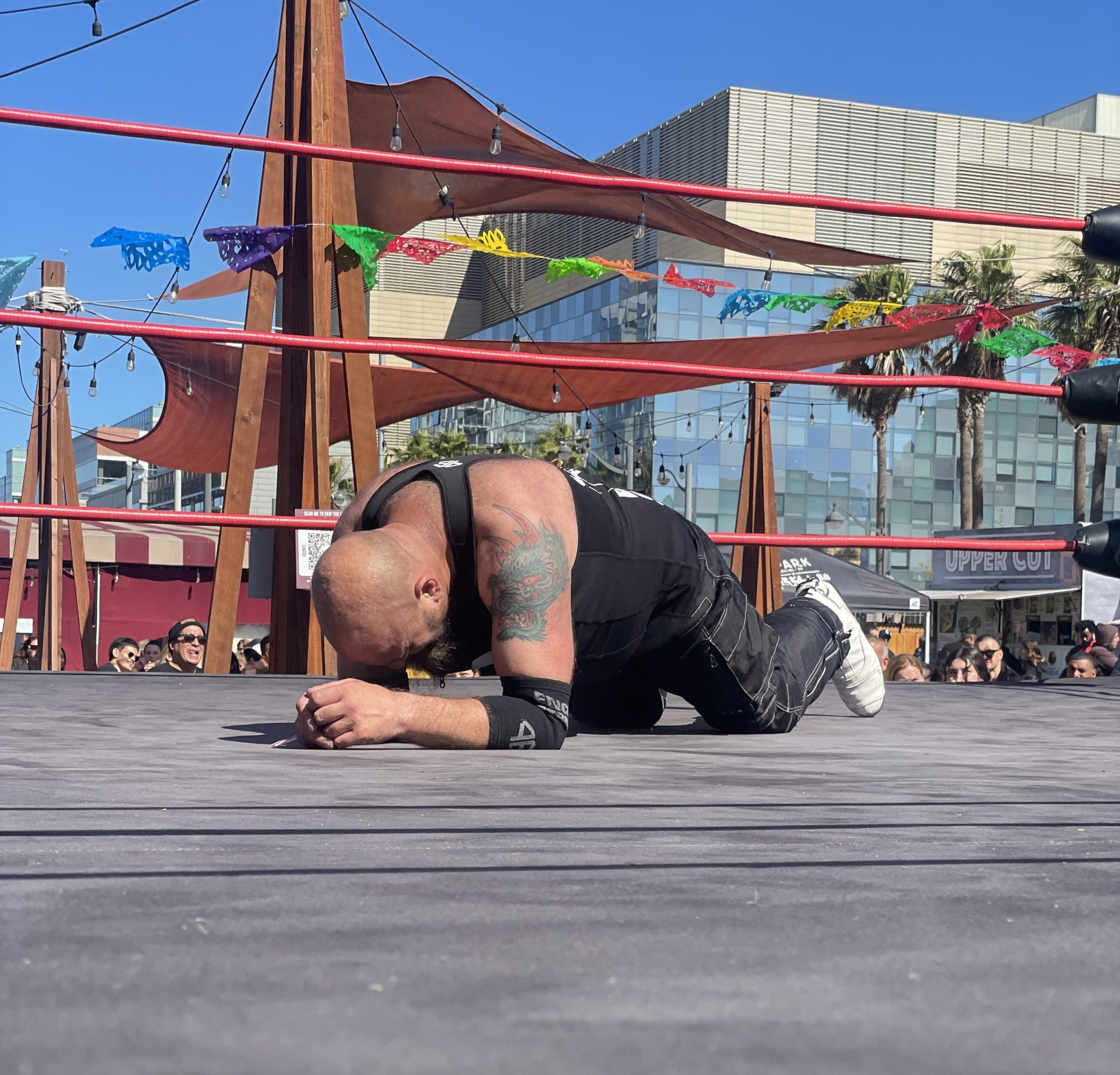 Michelada Mayhem-87 a person laying on wrestling ring