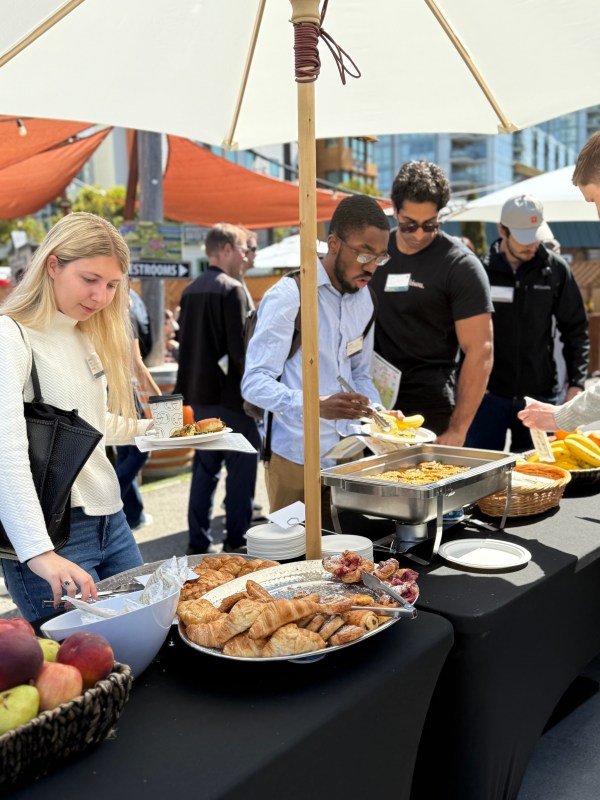 a group of people sitting at a table with food