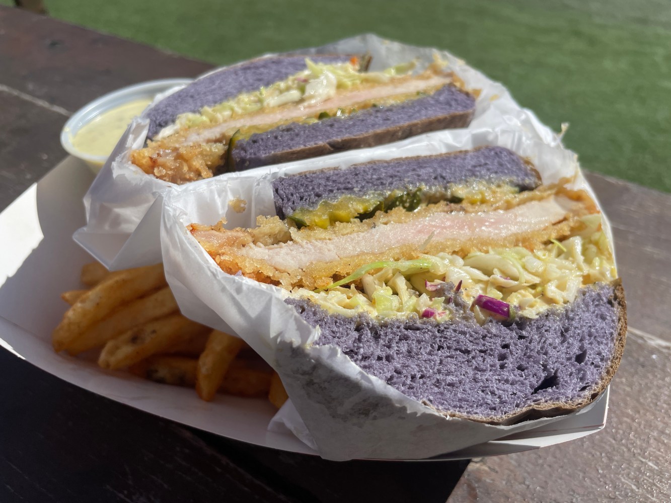 a sandwich sitting on top of a piece of cake on a plate