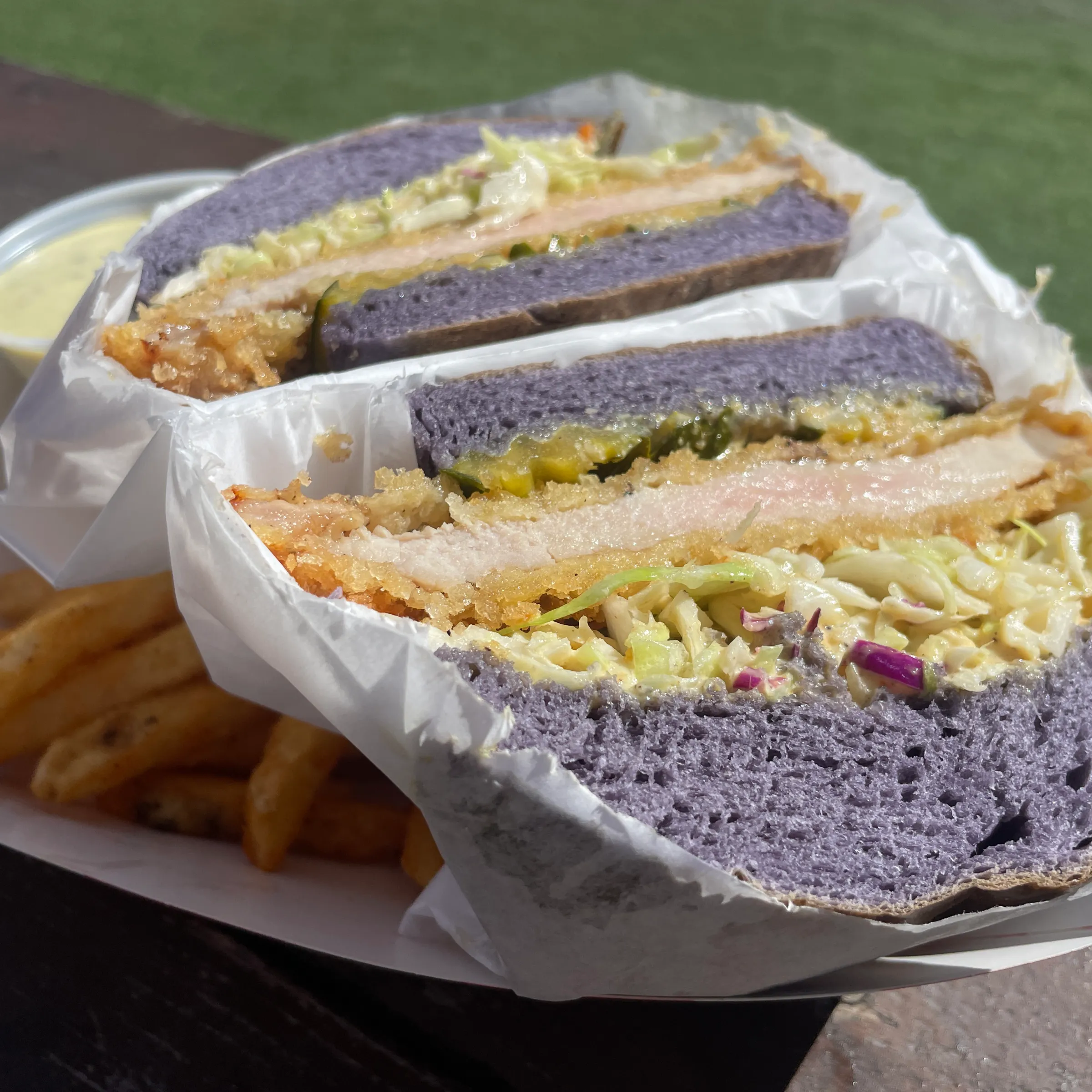 a sandwich sitting on top of a piece of cake on a plate